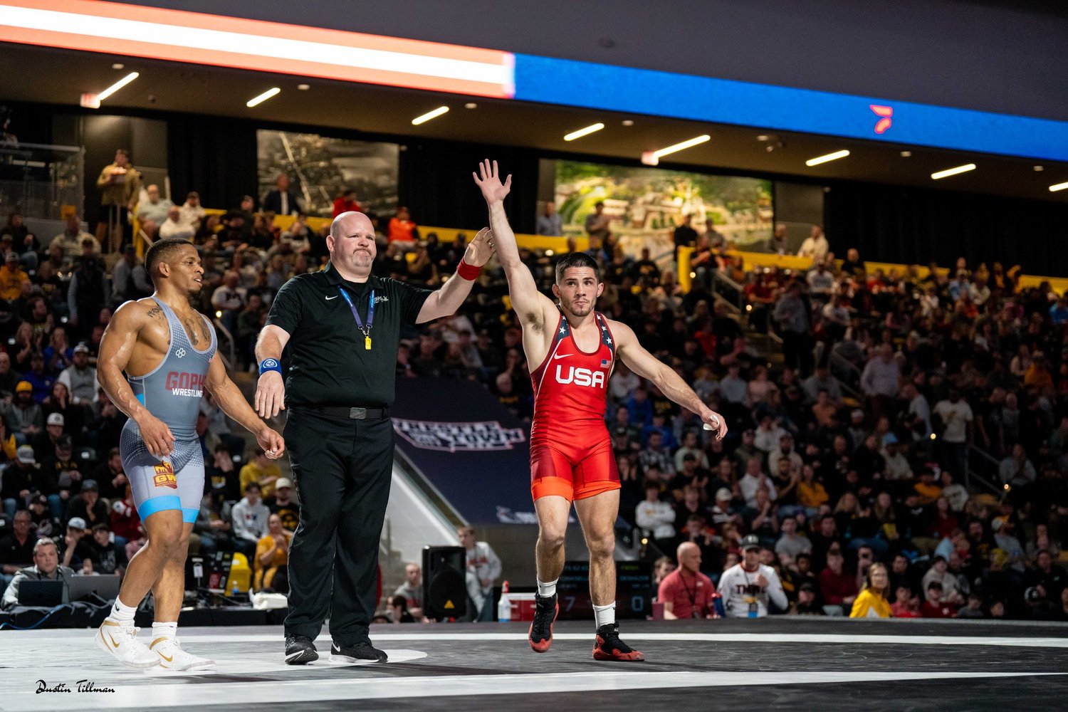 Nathan Tomasello coaching on a wrestling mat